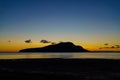 Sunrise over Holy Isle from Lamlash beach