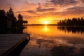 sunrise over lake with dock and cottage silhouette Royalty Free Stock Photo