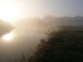 Sunrise over the lake. Foggy morning. Royalty Free Stock Photo