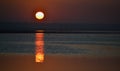 Sunrise over the lake, reflection of the red rays of the sun in the water, Ukraine, Tiligulsky estuary Royalty Free Stock Photo