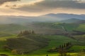 Sunrise over a lone farm in the middle of the hills of the Tuscany countryside,  Italy Royalty Free Stock Photo