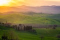 Sunrise over a lone farm in the middle of the hills of the Tuscany countryside,  Italy Royalty Free Stock Photo