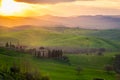 Sunrise over a lone farm in the middle of the hills of the Tuscany countryside,  Italy Royalty Free Stock Photo