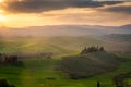 Sunrise over a lone farm in the middle of the hills of the Tuscany countryside,  Italy Royalty Free Stock Photo