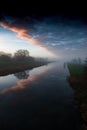 Sunrise over a major waterway in fenland