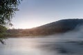 Sunrise over a misty river in Siberia in summer. Beautiful natural landscape. peace and tranquility, the gentle flow of
