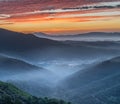 Sunrise over misty valleys