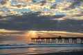 Sunrise over ocean horizon and pier. Royalty Free Stock Photo