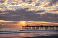 Sunrise over ocean horizon and pier. Royalty Free Stock Photo