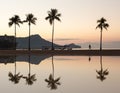 Sunrise over ocean with palm trees in Waikiki Hawaii Royalty Free Stock Photo