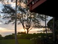 Sunrise over ocean with Red House with balcony