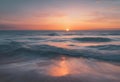 a sunrise over the ocean with some waves coming in to shore Royalty Free Stock Photo