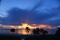 Clouds over the ocean appear blue as the sunrise begins