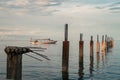 Sunrise hits the boat and broken pier - Cambodia