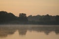 Sunrise over the Pripyat River in July. Foggy morning over the water. Royalty Free Stock Photo