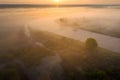 Sunrise over river. Sunny summer nature in sunlight. Amazing morning on riverside from above. Aerial nature landscape Royalty Free Stock Photo