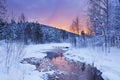 Sunrise over a river in winter near Levi, Finnish Lapland Royalty Free Stock Photo