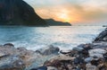 Sunrise over rocky beach and mountain background Royalty Free Stock Photo