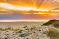 Sunrise over the sea and beautiful cloudscape. Colorful ocean beach sunrise with deep blue sky and sun rays. Warm golden light. Royalty Free Stock Photo