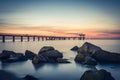 Sunrise over the sea bridge in Burgas bay. Vintage effect.