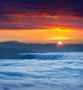 Sunrise over the sea of fog in the mountains Royalty Free Stock Photo