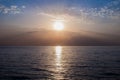 Sunrise over sea horizon. Bright sun is reflected from water surface, morning sky Royalty Free Stock Photo