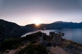 Sunrise over sea and mountains. Rocks and water senery Royalty Free Stock Photo