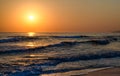 Sunrise over the sea, the rolling calm waves, sandy beach