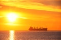 Sunrise over the sea with sailing cargo ship. Transportation. Logistics. Shipping. Royalty Free Stock Photo