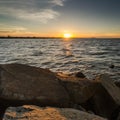 Sunrise over the sea, stone on the foreground. Royalty Free Stock Photo