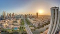 Sunrise over skyscrapers in Barsha Heights district and low rise buildings in Greens district aerial timelapse.