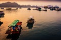 Sunrise over a small harbour with wooden fishing boats and rocks on Cat Ba Island. Catba, Vietnam - 03/02/2020 Royalty Free Stock Photo