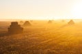 Sunrise over the stacks of straw Royalty Free Stock Photo