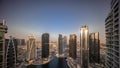 Sunrise over tall residential buildings at JLT aerial all day timelapse