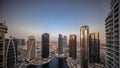 Sunrise over tall residential buildings at JLT aerial all day timelapse