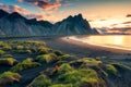 Sunrise over Vestrahorn mountain on black sand beach in Stokksnes peninsula at Iceland