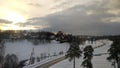 Sunrise over the village, Moscow region, Russia. Sun on the background of the road and trees