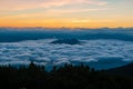 Sunrise over weather inversion clouds in Mountain ridge slopes of Rodna Mountains National Park multiday hike, Muntii Rodnei Royalty Free Stock Photo