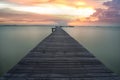 Sunrise over wooded bridge on the beach in Thailand