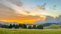 Sunrise paints Dolomites in radiant hues, morning light dances across Alpe di Siusi