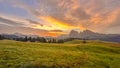 Sunrise paints Dolomites in radiant hues, morning light dances across Alpe di Siusi