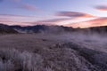 Sunrise paints the Sierra Sky pastel colors as mist rises
