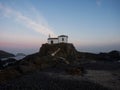 Sunrise panorama of atlantic coast chapel on rock cliff Ermida da Virxe do Porto Meiras Valdovino A Coruna Galicia Spain