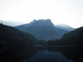 Sunrise panorama mirror reflection view of alpine forest mountain lake Piburger See Oetztal Alps Tyrol Austria Europe Royalty Free Stock Photo