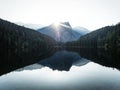 Sunrise panorama mirror reflection view of alpine forest mountain lake Piburger See Oetztal Alps Tyrol Austria Europe Royalty Free Stock Photo