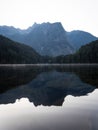 Sunrise panorama mirror reflection view of alpine forest mountain lake Piburger See Oetztal Alps Tyrol Austria Europe Royalty Free Stock Photo