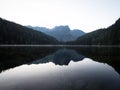 Sunrise panorama mirror reflection view of alpine forest mountain lake Piburger See Oetztal Alps Tyrol Austria Europe Royalty Free Stock Photo