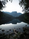 Sunrise panorama mirror reflection view of alpine forest mountain lake Piburger See Oetztal Alps Tyrol Austria Europe Royalty Free Stock Photo
