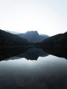 Sunrise panorama mirror reflection view of alpine forest mountain lake Piburger See Oetztal Alps Tyrol Austria Europe Royalty Free Stock Photo