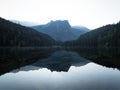 Sunrise panorama mirror reflection view of alpine forest mountain lake Piburger See Oetztal Alps Tyrol Austria Europe Royalty Free Stock Photo